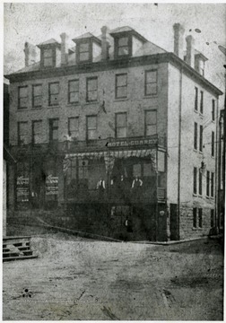 Men stand on the porch of the Hotel Currey in Monongah, W. Va. 1907.