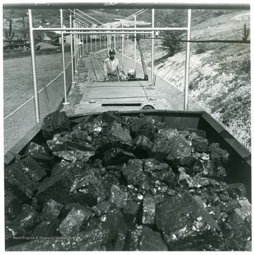 Vandivert J33#5-7--Haulage. Mine locomotive operator backing cut of cars into unloading yard. Note well-kept safety fence and grounds. Mine No. 32, Consolidation Coal Company, Owings, W. Va. Original photo August 1948, copy negative Jan. 1951. Use in 1950 BCI Annual, Page 15. 