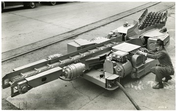 A man inspecting a Joy Continuous Miner.