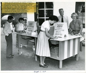 About 15,000 guessed at number of pieces of Disco in transparent barrel.  The number of pieces was changed each day of the Fair.  One day two people guessed the exact number and both won $100.00 worth of Disco.  Participants were limited to Solid Fuel users only.