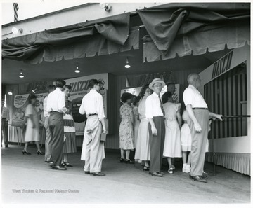 People mingle around looking at the various exhibits presented by Disco fuel.