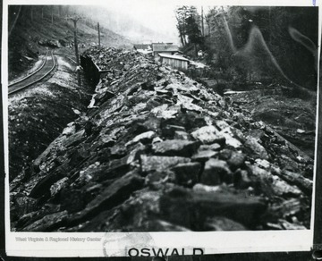 Coal train going past houses.