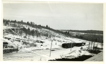 Coal cars on tracks in the winter time. 