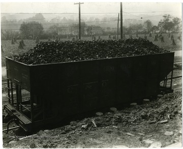 A Chesapeake and Ohio coal car, corn shocks in the background.