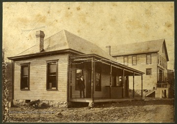 Most likely, John S. Jackson, store manager and postmaster standing on the porch.