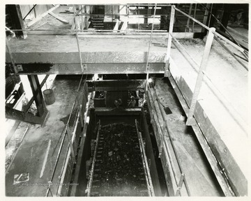 Coal in cars inside of a plant being processed.