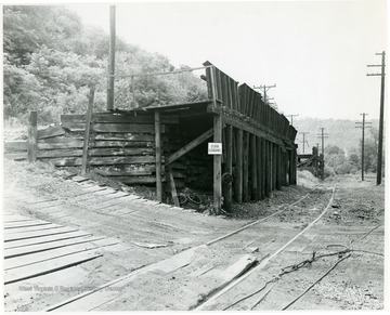 Unidentified coal loading platform alongside railroad tracks.