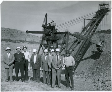 Men standing next to a shoveling machine at a Hanna Strip-Mine.