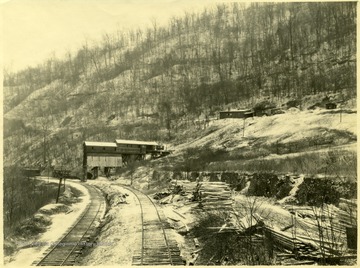 A tipple mine processing plants sits on the edge of a mountain.