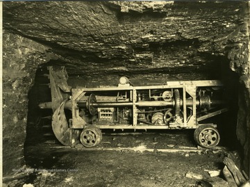 A gear driven cutting machine stands on the track.