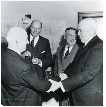 Two coal officials shaking hands during a Consolidation Coal Co. Inspection trip.