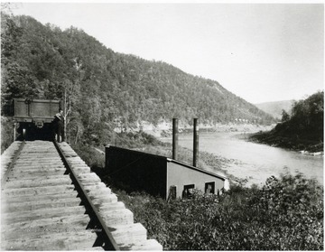 Man standing outside of a powerhouse at the New River Coal Co. mine in Caperton, W. Va.