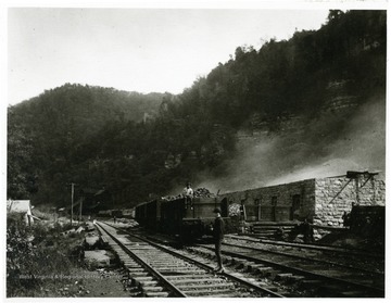 Men standing outside of the coke ovens at Fire Creek.