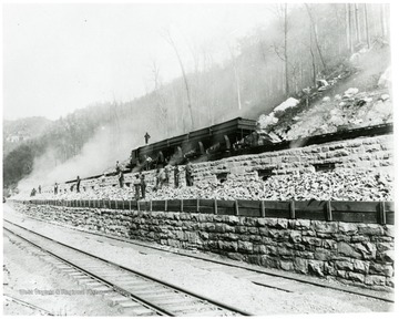 Men standing on near coke ovens of the New River Coal Co.