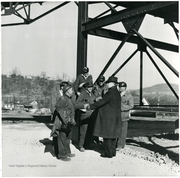 Coal official shaking hands with miners