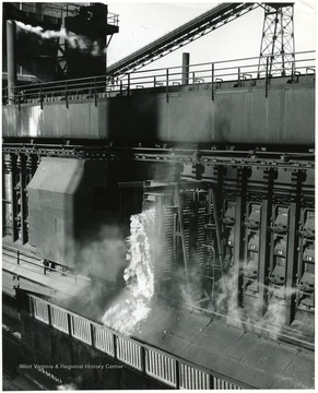 Burning coke pours from an oven.  Stamped on back: Joe Munroe, Box 508, Mt. Vernon, Ohio