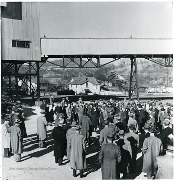 Group of miners and coal officials outside of mine building during a Consolidation Coal Co. Inspection trip.