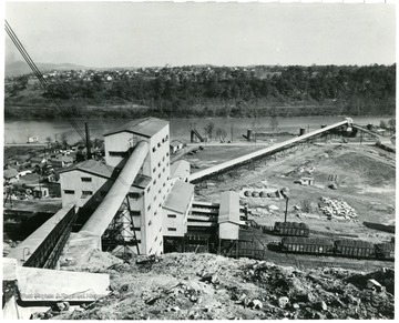 Coal building with a few houses next to it.