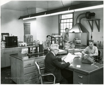 Four men working in the Pocahontas Fuel Company laboratory.