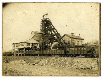 Caption on back reads, 'No misfortune can come to the coal miner, or operator, that does not touch every man, woman and child in Beckley. So, this picture of Beckley's greatest disaster at the Eccles mine, April 28, 1914, in which 181 men lost their lives. The photo is believed to have been taken very quickly after the (first) explosion, since the gondolas have not beed dropped out from under the tipple and the West Virginia mine rescue car does not appear to have arrived.'