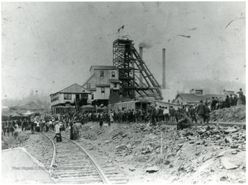 Crowds gather around the smoking buildings after an explosion at the Eccles mine.