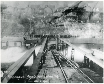 Crowds gather above and at the end of the trestle leading into mine no. 6 after the explosion.