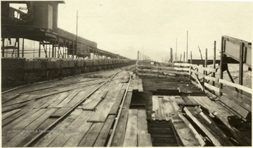 Wooden planks make up a railroad platform.