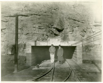 Two men stand outside of New Cinderella, 1942, mine portal.