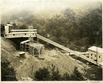 Buildings outside of a coal mine. There are small houses in the background.