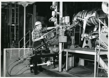 'A small portion of the hot ash-laden gas stream entering the turbine is continuously removed by this ash-sampling unit. Data from the operation of this unit is analyzed to determine the concentration, size, and composition of the ash in the hot gases entering the turbine.'