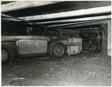 Miner watches as coal loads into a shuttle car.