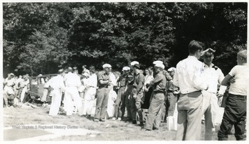 Group of men rehearsing mine safety procedures. 