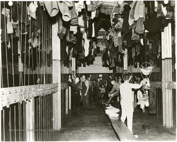 Miners taking their clothes down in their locker room.