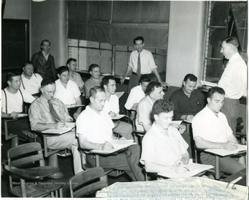 Group of mine foremen listen during an instruction course.  Center rear is Clyde Sutherland.