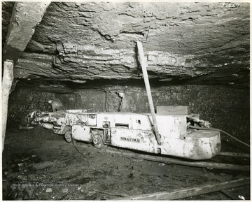 Two miners operate a Sullivan cutting machine.