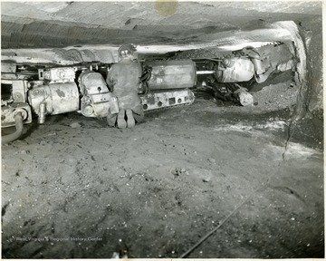 Miner operating a Joy continuous mining machine.