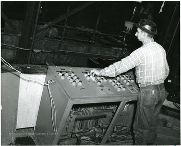 Miner operating the Railroad car loading control panel.