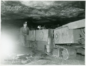 Miner running a continuous mining machine.