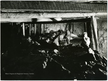 Three miners hard at work as coal comes down a conveyor.  Copyright Photo by William Vandivert, 21 East Tenth Street, New York 3, N. Y. 