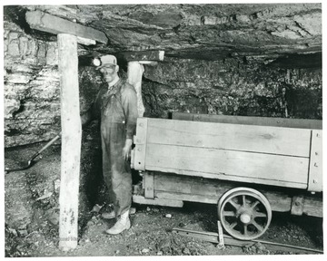 Interior of mine shows properly timbered places and spragged car.