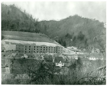 View of school with children lined up outside.