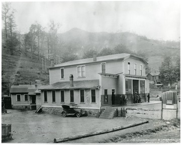 Men stand in front of what looks to be a company store.