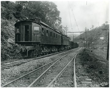 Man sticking his head out of a window on a train.