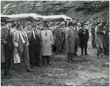 Group portrait of business men standing around.