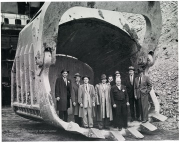 Group portrait of men standing in a scoop.