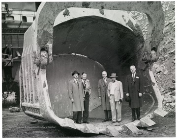 Five men stand in a scoop.