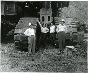 People standing by 2 of the Mountaineers 8'8'' crawlers (Cats).