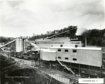 Baltimore and Ohio Railroad cars pass under the preparation plant buildings.