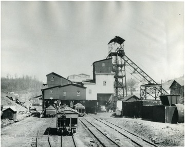 Plant with filled Chesapeake and Ohio railroad cars beside of it.