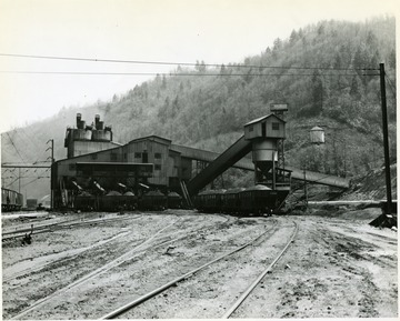 Railroad cars outside preparation plant buildings.